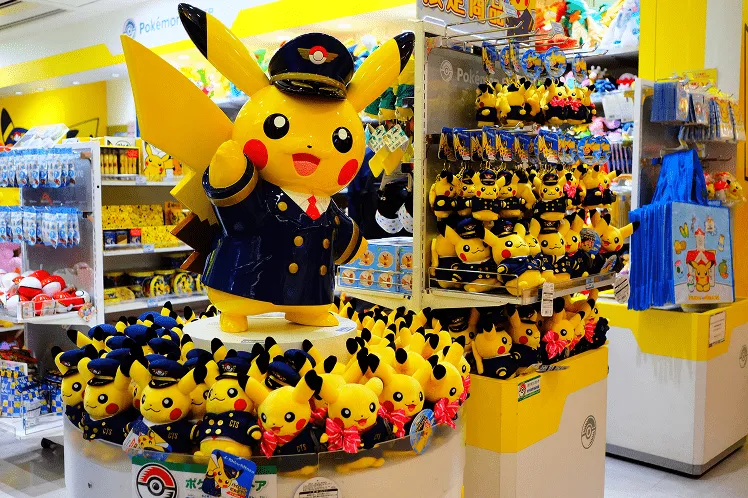 A vibrant collection of Pokémon Center exclusive merchandise includes plushies of popular characters, collectible items, and themed stationery in official Pokémon stores in Japan