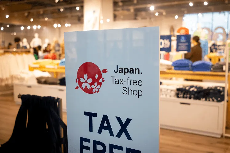 A tax-free shop sign displayed in front of a clothing store in Japan
