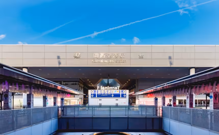 A quiet morning scene in front of Kansai Airport Station, captured under a clear blue sky