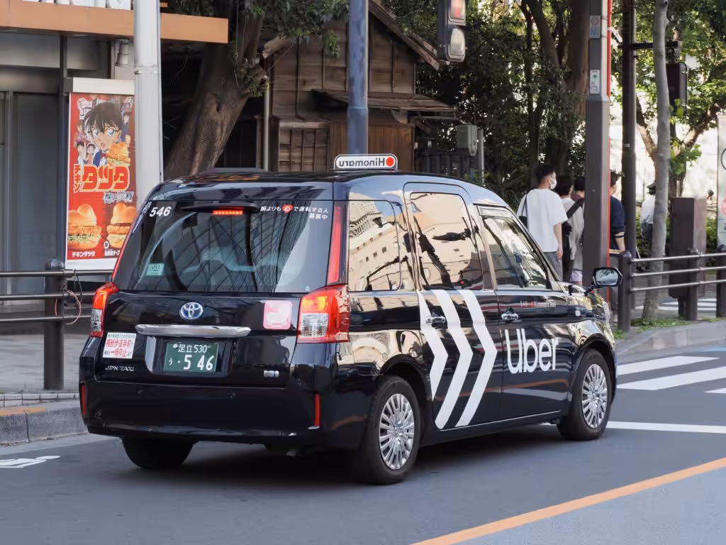 Black Uber taxi in the middle of the road in Japan