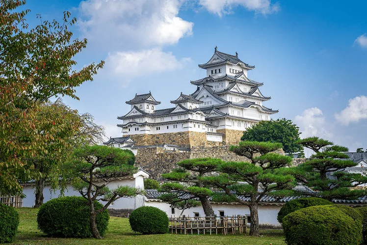 Himeji Castle, also called White Heron Castle, standing brightly under the clear blue sky