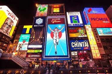 Downtown Osaka featuring iconic Glico running man and colourful bright neon lights up the streets